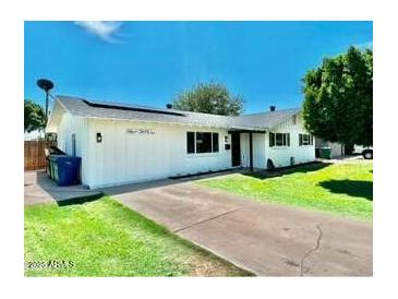 Charming single story home with a well-manicured lawn and a paved driveway at 1539 E 3Rd St, Mesa, AZ 85203