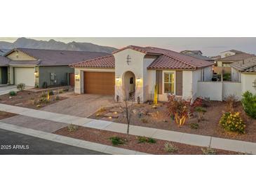 Single-story home with a two-car garage and desert landscaping at 19930 W Exeter Blvd, Litchfield Park, AZ 85340