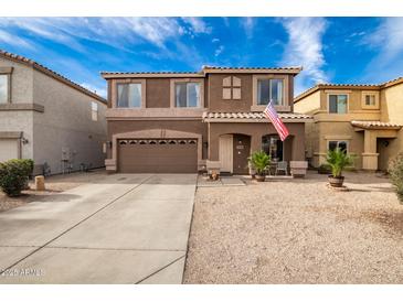 Two-story house with a brown exterior, two-car garage, and landscaped front yard at 30084 N Desert Willow Blvd, San Tan Valley, AZ 85143