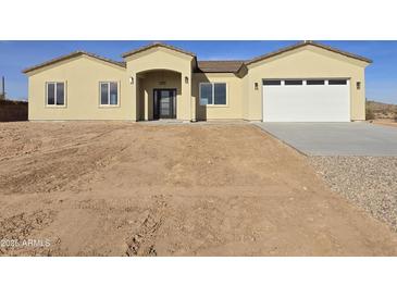 New single-story home with a two-car garage and desert landscaping at 33406 W Campbell Ave, Tonopah, AZ 85354