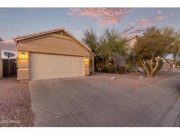 Tan house with two-car garage and desert landscaping at 4322 E South Fork Dr, Phoenix, AZ 85044