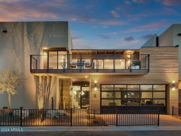 Modern two-story home with wood and metal accents, balcony, and attached garage at 6525 E Cave Creek Rd # 14, Cave Creek, AZ 85331