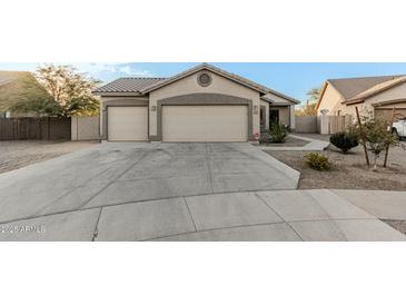 Single-story home with two-car garage and desert landscaping at 6910 S 26Th Ln, Phoenix, AZ 85041