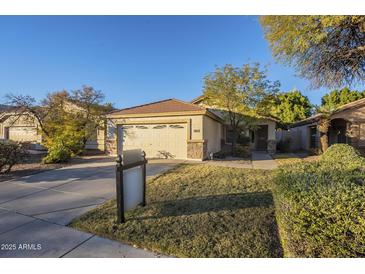 Single-story house with a two-car garage and well-maintained lawn at 896 E Windsor Dr, Gilbert, AZ 85296