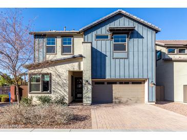 Two-story home with blue siding, neutral accents, and a two-car garage at 1110 S Jay St, Chandler, AZ 85286