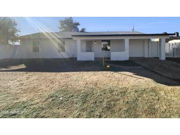 Newly renovated single-story home with a spacious front yard at 130 N 95Th Pl, Mesa, AZ 85207