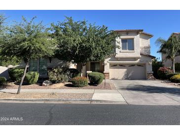 Two-story house with landscaped yard and two-car garage at 18546 E Oak Hill Ln, Queen Creek, AZ 85142