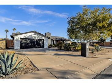 Ranch style home with a landscaped front yard, driveway, and two-car garage at 2366 E Becker Ln, Phoenix, AZ 85028