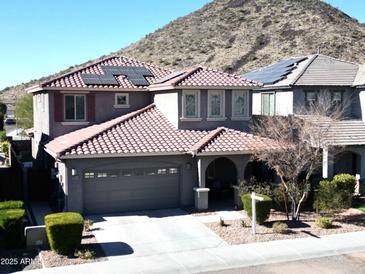 Two-story house with solar panels, gray exterior, and red tile roof at 25210 N 54Th Dr, Phoenix, AZ 85083