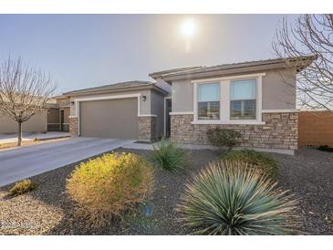 Single-story home with stone accents and a two-car garage at 25973 W Horsham Dr, Buckeye, AZ 85396