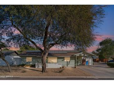 Updated mid-century home with solar panels and a landscaped front yard at 3105 N 21St St, Phoenix, AZ 85016