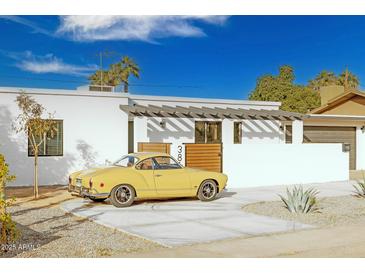 Stunning mid-century modern home with a remodeled exterior and landscaped yard at 3810 E Shea Blvd, Phoenix, AZ 85028