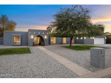 Stunning curb appeal with modern gray exterior, landscaping, and a welcoming walkway at 5429 E Bloomfield Rd, Scottsdale, AZ 85254