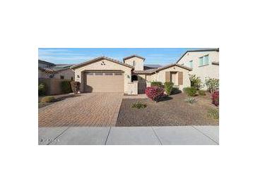 Beautiful two-story home with a three-car garage and well-manicured landscaping at 5450 W Taro Ln, Glendale, AZ 85308