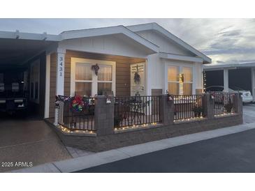 Well-maintained manufactured home with festive lights and a fenced patio at 650 N Hawes Rd # 3431, Mesa, AZ 85207