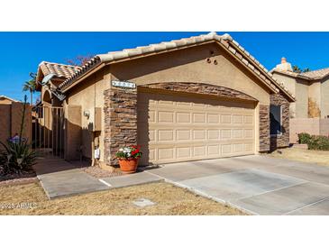 House exterior featuring stone accents and a two-car garage at 660 N Maple St, Chandler, AZ 85226