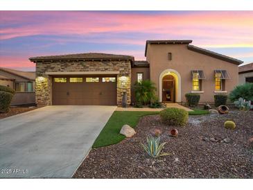 Single-story home with stone accents and landscaped front yard at 12935 W Lone Tree Trl, Peoria, AZ 85383