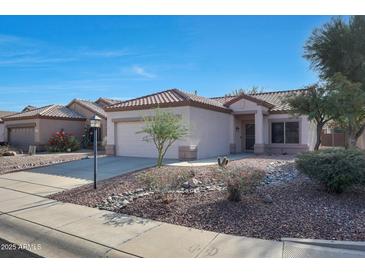 Single-story house with desert landscaping and a two-car garage at 15893 W Arrowhead Dr, Surprise, AZ 85374