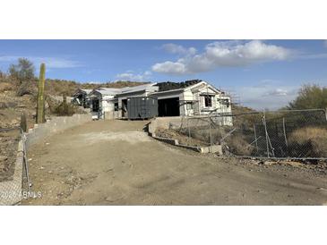 Under construction home with stucco exterior and large windows at 16025 N Ringtail Trl, Fountain Hills, AZ 85268