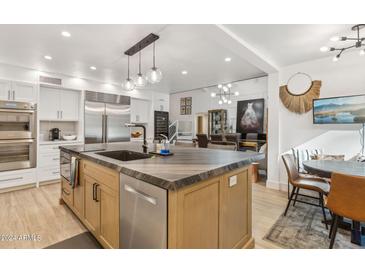 Modern kitchen with island, stainless steel appliances, and light wood cabinets at 2108 E Pasadena Ave, Phoenix, AZ 85016