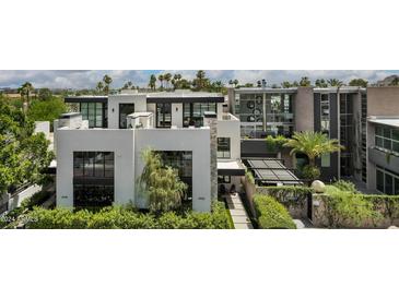 Modern architectural home with a clean design and lush landscaping at 6933 E 1St St # B, Scottsdale, AZ 85251