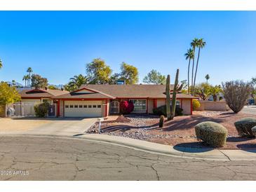 Single-story home with a two-car garage and desert landscaping at 13601 N 50Th Pl, Scottsdale, AZ 85254