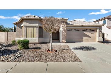 Single-story home with a two-car garage and desert landscaping at 1803 N Desert Willow St, Casa Grande, AZ 85122