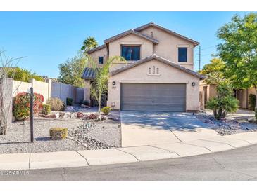 Two-story house with gray garage door and desert landscaping at 20219 N 33Rd Pl, Phoenix, AZ 85050