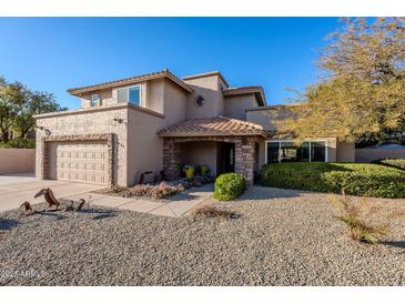 Two-story house with stone accents and a landscaped front yard at 5432 E Grandview Rd, Scottsdale, AZ 85254