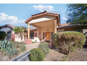 Front view of a single-story home with a covered porch and landscaped yard at 5819 S 102Nd Dr, Tolleson, AZ 85353