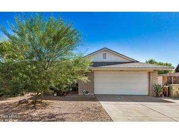 Brick house with a white garage door and desert landscaping at 6810 W Vermont Ave, Glendale, AZ 85303