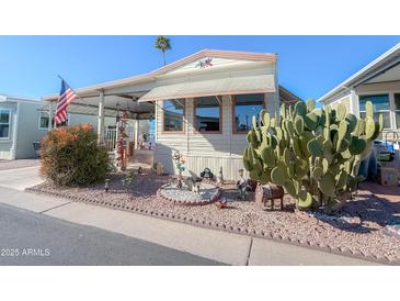 Inviting manufactured home exterior, landscaped yard, and covered carport at 7750 E Broadway Rd # 123, Mesa, AZ 85208