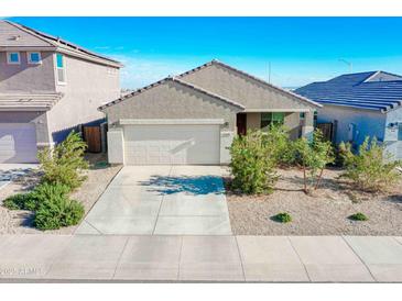 Single-story house with a two-car garage and desert landscaping at 8637 N 168Th Dr, Waddell, AZ 85355