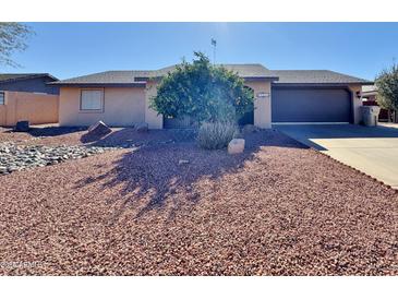 Single-story home with a landscaped front yard and driveway at 9283 W Rafael Dr, Arizona City, AZ 85123