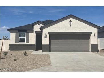 Charming single-story home featuring a two-car garage and low maintenance front yard at 109 S Collier Ln, Casa Grande, AZ 85122