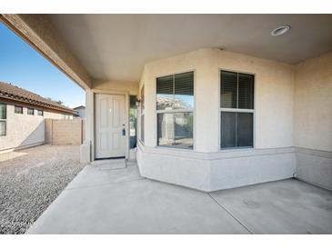 Tan house exterior with covered patio, door, and window at 1125 W Fruit Tree Ln, San Tan Valley, AZ 85143