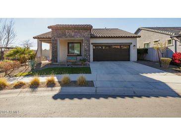 Single-story home with stone accents and a two-car garage at 20487 W Minnezona Ave, Buckeye, AZ 85396