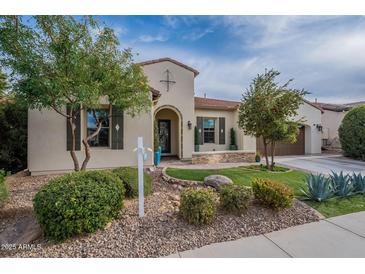 Charming single-Gathering home featuring desert landscaping, a front lawn, and a covered entryway at 36925 N Stoneware Dr, Queen Creek, AZ 85140