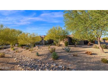 Desert landscaping surrounds this single-story home with a large front yard at 5650 E Villa Cassandra Way, Carefree, AZ 85377