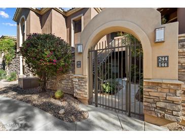 Attractive gated entrance to the community with landscaping and stonework at 7027 N Scottsdale Rd # 243, Paradise Valley, AZ 85253