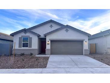 Charming single-story home showcasing a well-manicured lawn and a two-car garage at 8283 W Mantle Way, Florence, AZ 85132