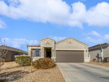 Single-story home with a two-car garage and desert landscaping at 11468 E Sunflower Ln, Florence, AZ 85132