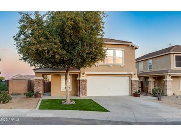 Two-story house with a landscaped yard and a two-car garage at 11935 N 148Th Ave, Surprise, AZ 85379