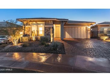 Stunning curb appeal: single-story home with landscaped yard and 2-car garage at 12007 W Creosote Dr, Peoria, AZ 85383