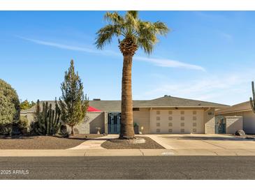 Single-story home with landscaped yard and two-car garage at 12526 W Paintbrush Dr, Sun City West, AZ 85375