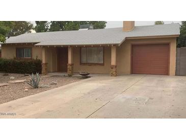 Tan one-story house with a two-car garage and stone pillars at 1312 E Coolidge St, Phoenix, AZ 85014