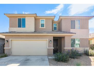 Two-story house with a neutral color scheme and a two-car garage at 18443 W Villa Chula Ln, Surprise, AZ 85387