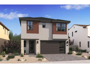 Two-story home with modern design, brown accents, and a two-car garage at 2024 N Woodburne Pl, Chandler, AZ 85224