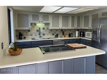 Modern kitchen with stainless steel appliances and an island at 2524 S El Paradiso -- # 106, Mesa, AZ 85202