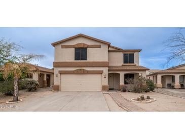 Two-story house with a beige exterior, attached garage, and landscaping at 30788 N Whirlaway Trl, San Tan Valley, AZ 85143